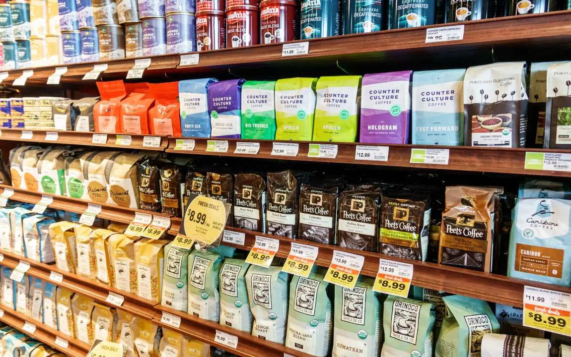 Grocery store shelves of mass produced coffee.