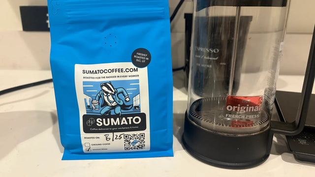 Freshly roasted Sumato Coffee beside a simple French press brewing setup