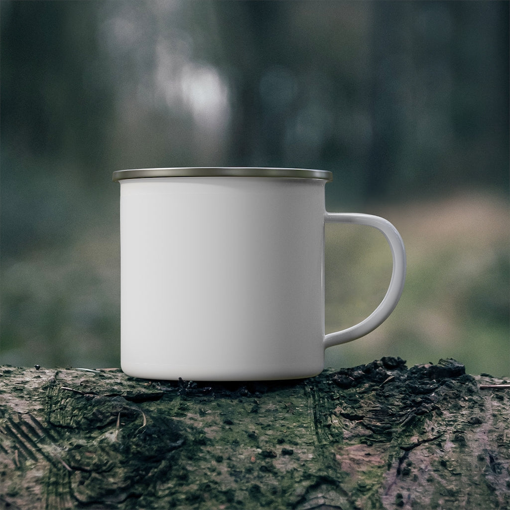 White enamel camping mug with metal rim resting on a log in the forest – rugged and ready for outdoor coffee moments